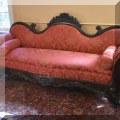 F09. Rococo Revival Victorian sofa with scrolled arms and 2 bolster pillows 